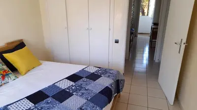 a bedroom with a bed with a blue and white quilt at Adarissa House in Rabat
