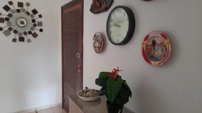 a room with clocks and a plant on a wall at Adarissa House in Rabat