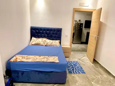 a small bedroom with a blue bed in a room at Bel Appartement à AMWAJ Sidi rahal in Casablanca