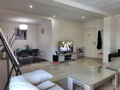 a living room with a couch and a tv at Luxury Spacious Apartment Midtown Casablanca in Casablanca