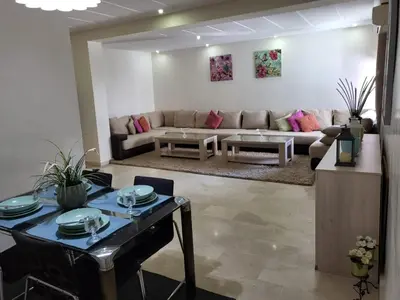 a living room with a couch and a table at Luxury Spacious Apartment Midtown Casablanca in Casablanca