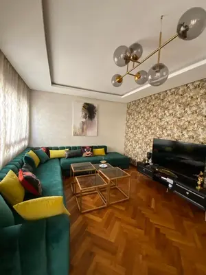a living room with a green couch and a piano at Casa finance city apartment in Casablanca