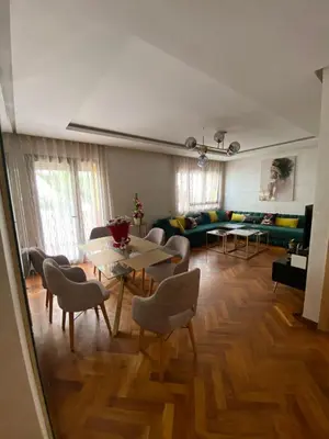 a living room with a table and chairs and a couch at Casa finance city apartment in Casablanca