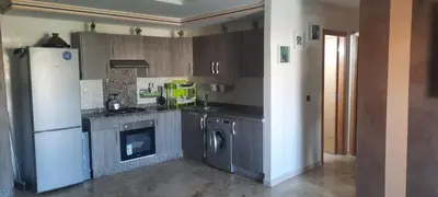 a kitchen with a white refrigerator and a dishwasher at Bel appart à Hacienda Beach Sidi Rahal in Sidi Rahal
