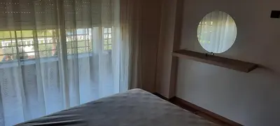 a bedroom with a bed and a mirror and a window at Bel appart à Hacienda Beach Sidi Rahal in Sidi Rahal