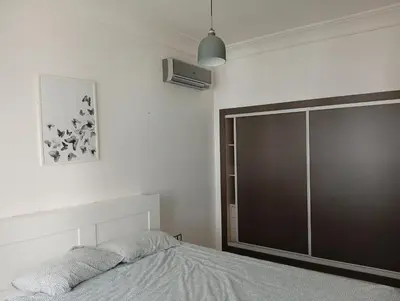a bedroom with a bed and a large closet at luxu appart siesta beach resort in Mohammedia