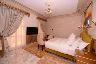 a hotel room with a bed and a desk and a television at THE WHITE PALACE Rabat in Rabat
