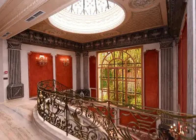 an ornate staircase in a building with a large window at THE WHITE PALACE Rabat in Rabat