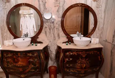 a bathroom with two sinks and two mirrors at THE WHITE PALACE Rabat in Rabat