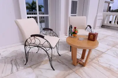 a living room with two chairs and a table at THE WHITE PALACE Rabat in Rabat