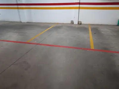 an empty parking lot with yellow and red lines at Appartement Résidence fermée in Casablanca
