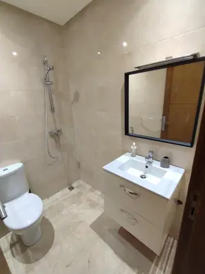 a bathroom with a toilet and a sink and a shower at Appartement Résidence fermée in Casablanca