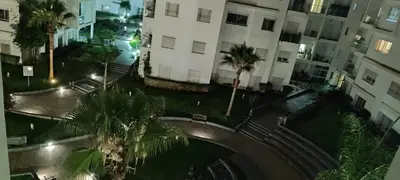 an aerial view of a street with palm trees and buildings at Appartement Résidence fermée in Casablanca
