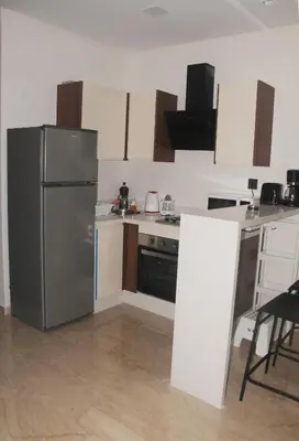 a kitchen with a stainless steel refrigerator and a stove at SUITE APPARTEMENT BOURGOGNE 2 pièces in Casablanca