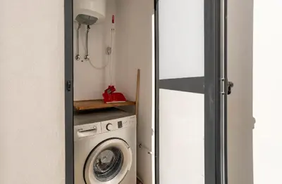 a laundry room with a washer and a washer and dryer at SUITE APPARTEMENT BOURGOGNE 2 pièces in Casablanca