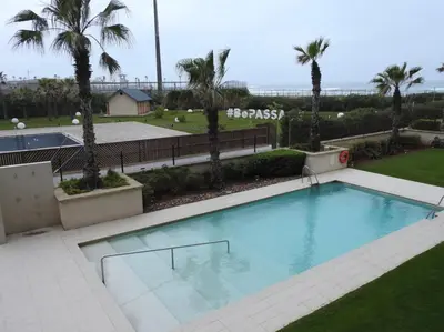 a large swimming pool with palm trees in the background at Anfa Place, Art Deco Luxury Apartment, Sunny Ocean View in Casablanca