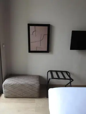 a bedroom with a bed and a chair and a picture at Anfa Place, Art Deco Luxury Apartment, Sunny Ocean View in Casablanca