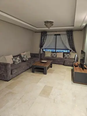 a living room with a couch and a table at LUXURY 3 bedroom apartment with pool, Nouaceur, Morocco in Derroua