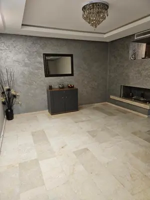 a living room with a television and a fireplace at LUXURY 3 bedroom apartment with pool, Nouaceur, Morocco in Derroua