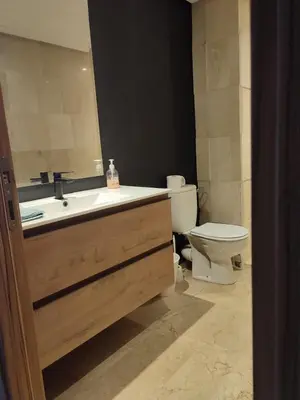 a bathroom with a sink and a toilet at LUXURY 3 bedroom apartment with pool, Nouaceur, Morocco in Derroua