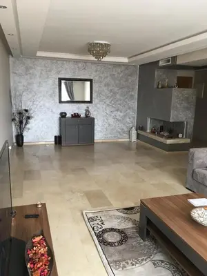 a living room with a couch and a table at LUXURY 3 bedroom apartment with pool, Nouaceur, Morocco in Derroua