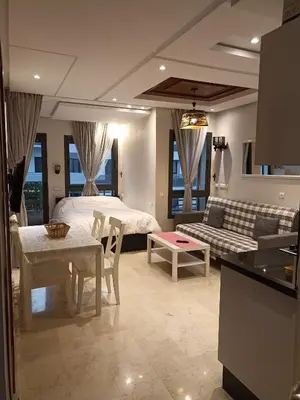 a living room with a bed and a couch at La Gironde - Sweet Home - Casablanca in Casablanca