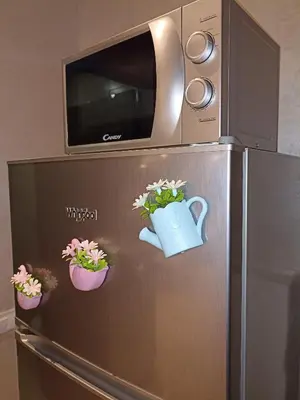 a refrigerator with a microwave on top of it at La Gironde - Sweet Home - Casablanca in Casablanca