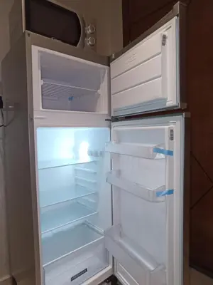 an empty refrigerator with its door open in a kitchen at La Gironde - Sweet Home - Casablanca in Casablanca