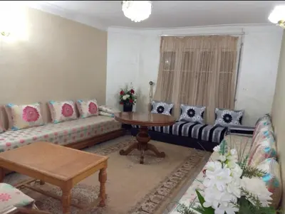 a living room with a couch and a table at Apartment in the center of Casablanca in Roches Noires