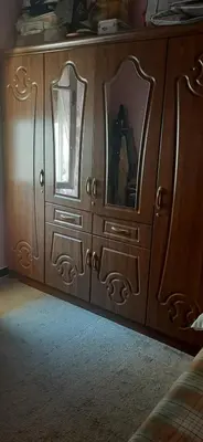 a wooden dresser with two mirrors in a bedroom at Apartment in the center of Casablanca in Roches Noires