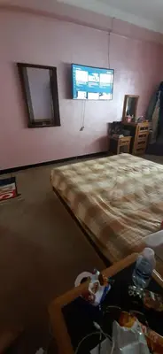 a bedroom with a bed and a tv on the wall at Apartment in the center of Casablanca in Roches Noires