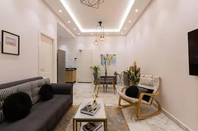 a living room with a couch and a table at Airport Apartment Suite Casablanca FREE WIFI Modern Confort Calme in Derroua