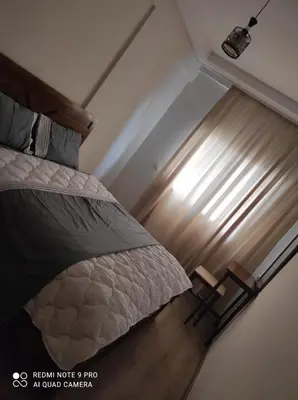a bedroom with a bed and a window at Apartment place italie in Rabat