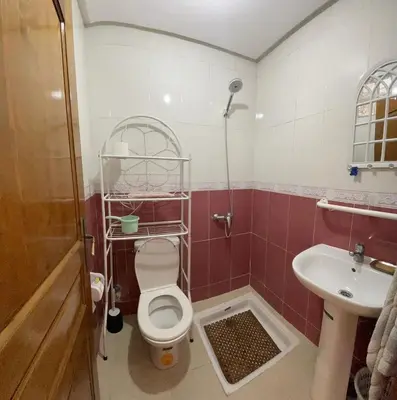 a bathroom with a toilet and a sink at Bel Appartement au cœur de BOUZNIKA in Bouznika