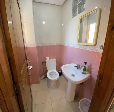 a bathroom with a toilet and a sink at Bel Appartement au cœur de BOUZNIKA in Bouznika