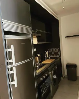a kitchen with a stainless steel refrigerator and a stove at Appartement haut standing au quartier les princesses avec grande terrasse et parking gratuit in Casablanca