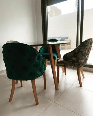 a dining room table and two chairs and a table at Appartement haut standing au quartier les princesses avec grande terrasse et parking gratuit in Casablanca