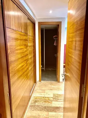 a hallway with a wooden door and a hallway leading into a room at Future apartments in Casablanca