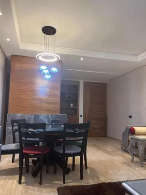 a dining room with a black table and chairs at Future apartments in Casablanca