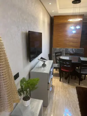 a living room with a table and a dining room at Future apartments in Casablanca