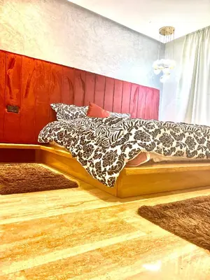 a bedroom with a bed with a black and white blanket at Future apartments in Casablanca