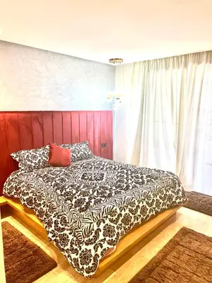 a bedroom with a black and white comforter on a bed at Future apartments in Casablanca
