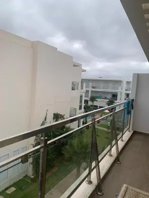 a view of a balcony of a building at Appartement à louer dans une résidence balnéaire 3 piscines - RAMOFLORES Sidi Rahal in Sidi Rahal