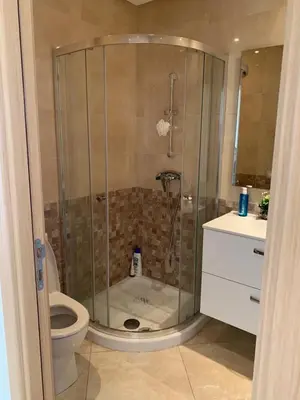 a bathroom with a shower and a toilet at Appartement à louer dans une résidence balnéaire 3 piscines - RAMOFLORES Sidi Rahal in Sidi Rahal