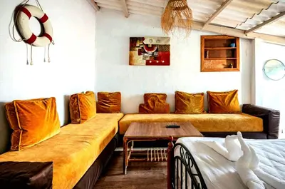 a living room with a couch and a table at Charmante Maison vue sur mer à Mohammédia plage Manesmane ! in Mohammedia