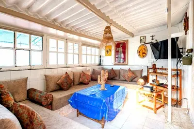 a living room with a couch and a table at Charmante Maison vue sur mer à Mohammédia plage Manesmane ! in Mohammedia