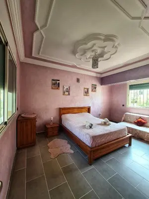 a bedroom with a large bed and a couch at Dar Babou in Rabat