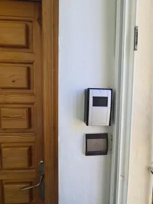 a television on a wall next to a door at Dar Babou in Rabat