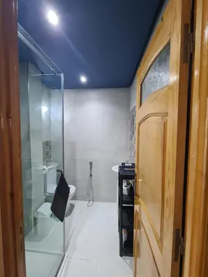 a bathroom with a glass shower and a toilet at Dar Babou in Rabat