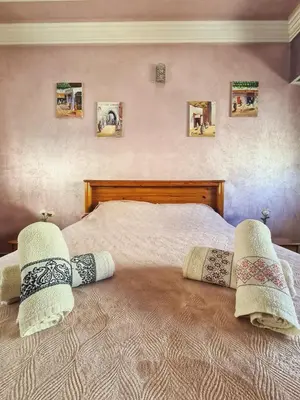 a bedroom with a bed with two pillows on it at Dar Babou in Rabat